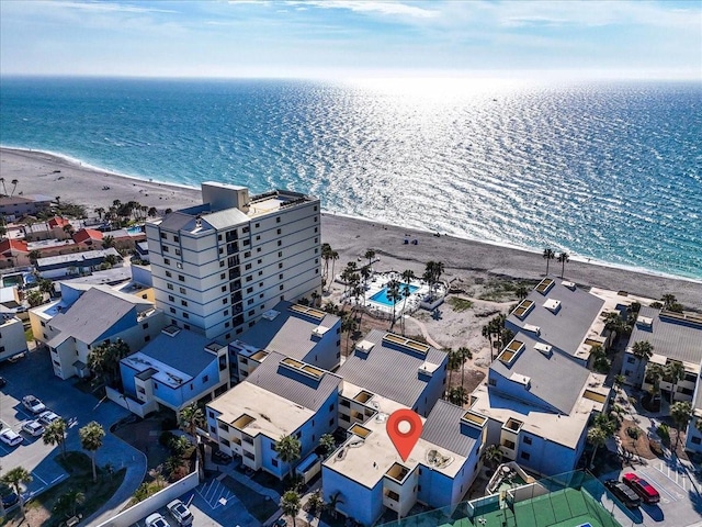 drone / aerial view with a water view and a beach view