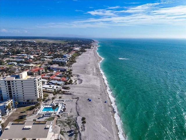 drone / aerial view with a beach view and a water view