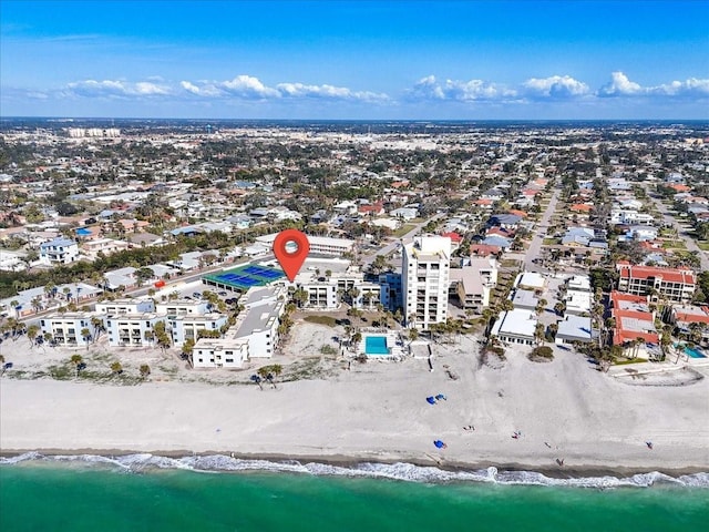 bird's eye view featuring a water view and a beach view