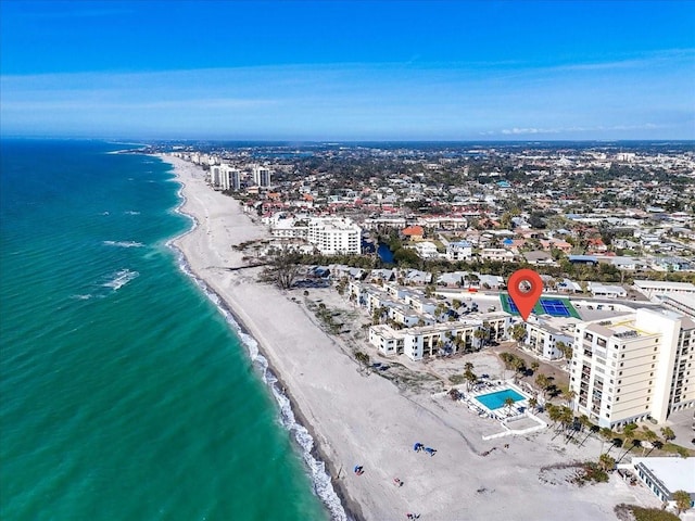 drone / aerial view with a water view and a beach view