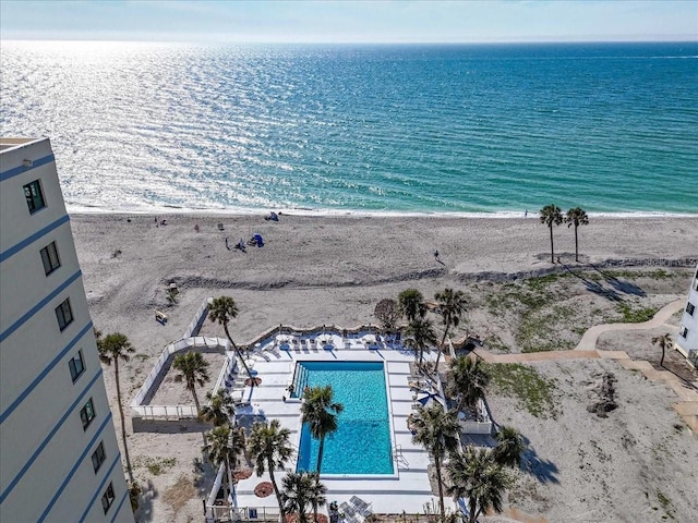 birds eye view of property featuring a water view and a beach view