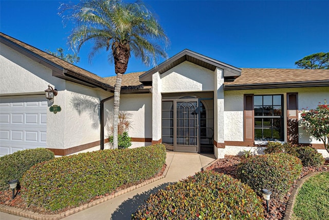 view of exterior entry featuring a garage