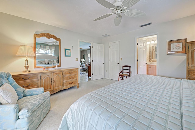 carpeted bedroom with ceiling fan and ensuite bath