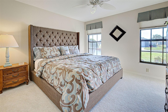 bedroom featuring light colored carpet and ceiling fan