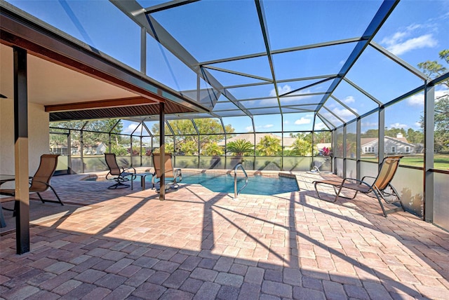 view of pool featuring a patio area and glass enclosure