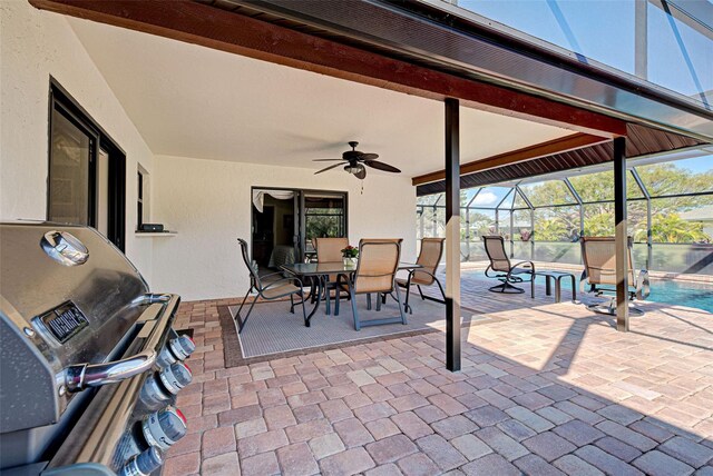 view of patio with a grill, ceiling fan, and glass enclosure