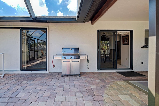 view of patio / terrace featuring area for grilling and glass enclosure