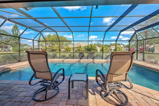 view of pool featuring a patio area and glass enclosure