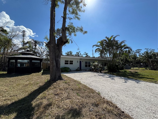 view of front of property featuring a gazebo and a front lawn