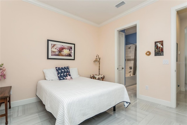 bedroom with crown molding and ensuite bathroom