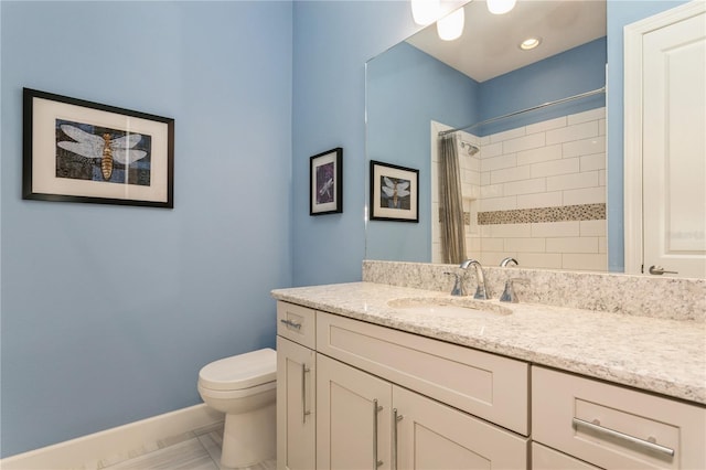 bathroom with toilet, vanity, and a shower with shower curtain