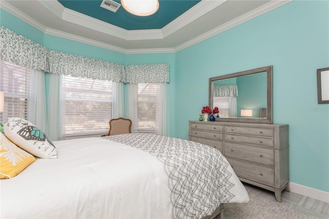 bedroom with crown molding and a tray ceiling