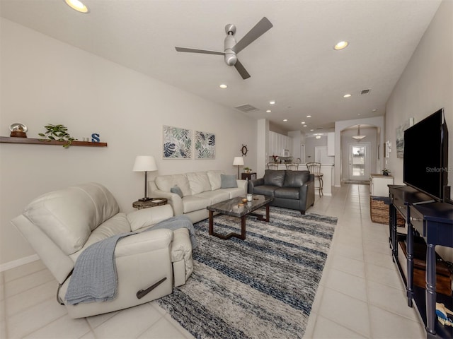 living room with ceiling fan and light tile patterned flooring