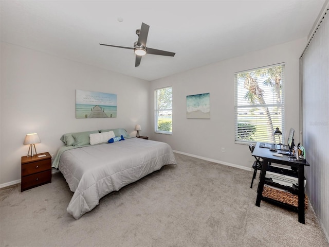 bedroom featuring light colored carpet and ceiling fan