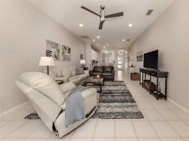 living room featuring light tile patterned floors and ceiling fan