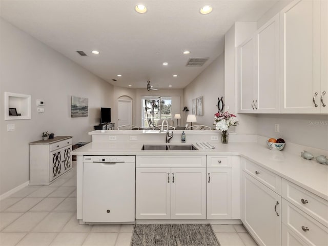 kitchen with white dishwasher, sink, white cabinetry, and kitchen peninsula