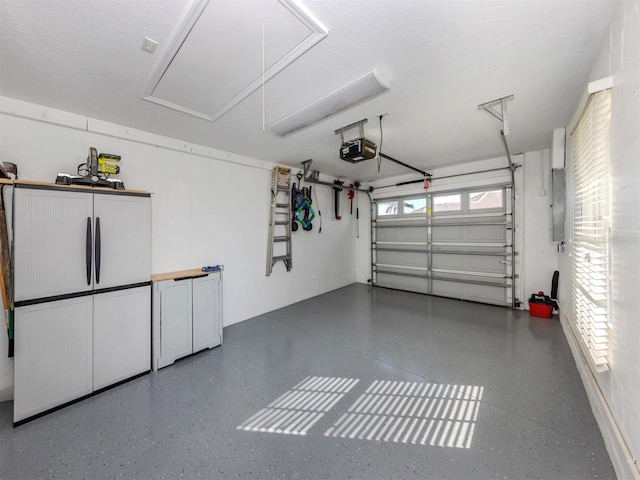 garage featuring a garage door opener and refrigerator