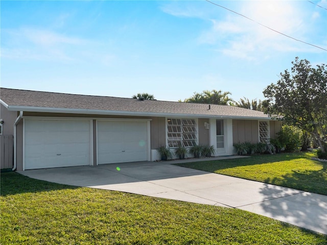 single story home with a garage and a front yard