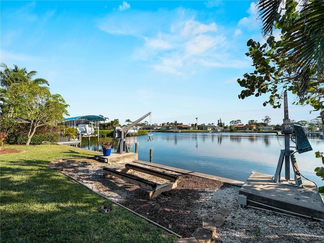 dock area with a yard and a water view