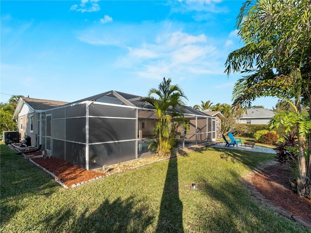 view of yard with a lanai, cooling unit, and a patio area