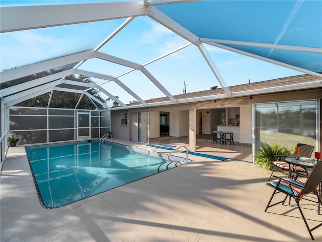 view of swimming pool featuring a patio, a lanai, and exterior bar