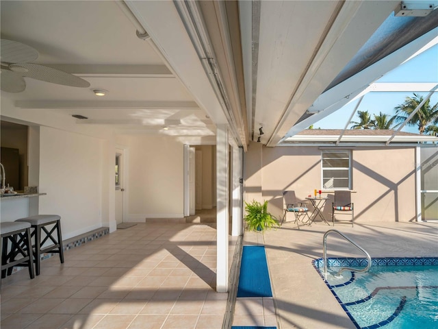 view of patio / terrace featuring ceiling fan and a lanai