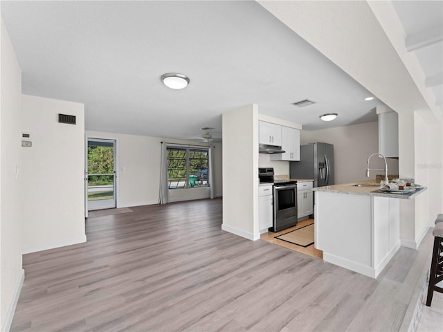 kitchen featuring appliances with stainless steel finishes, sink, white cabinets, ceiling fan, and light hardwood / wood-style floors