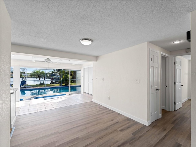 empty room featuring wood-type flooring and a textured ceiling