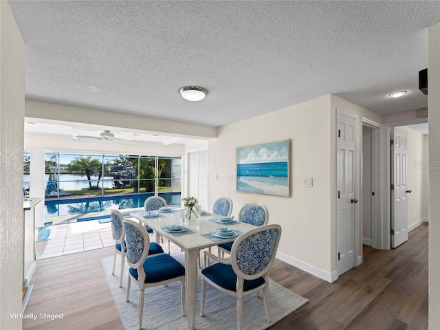 18053 Cullman Ave, Port Charlotte, FL 33948 - dining area with a textured ceiling, baseboards, and wood finished floors