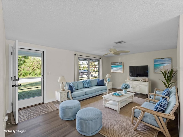 18053 Cullman Ave, Port Charlotte, FL 33948 - living area with a ceiling fan, wood finished floors, visible vents, and a textured ceiling