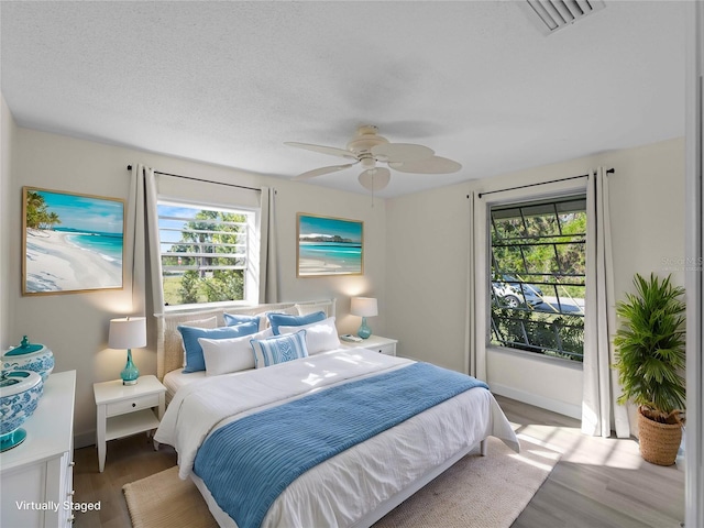 18053 Cullman Ave, Port Charlotte, FL 33948 - bedroom with visible vents, baseboards, ceiling fan, and wood finished floors