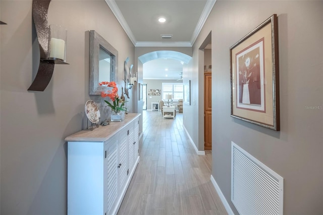 hallway featuring crown molding and light hardwood / wood-style floors