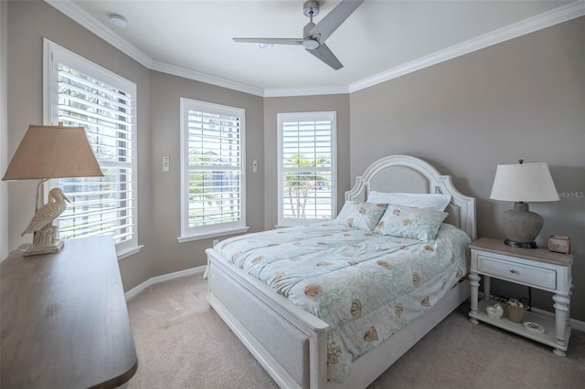 carpeted bedroom with ornamental molding and ceiling fan