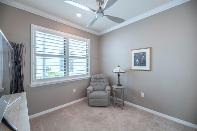 sitting room with crown molding, light colored carpet, and ceiling fan