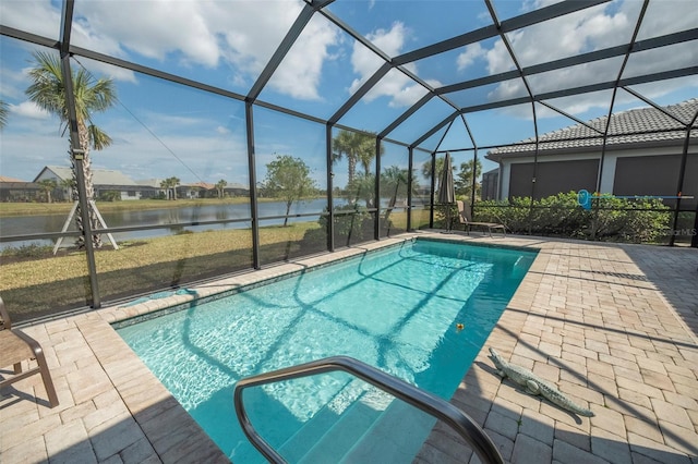 view of swimming pool featuring a patio, a water view, and glass enclosure