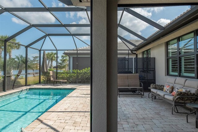 view of swimming pool featuring a water view, outdoor lounge area, a lanai, and a patio