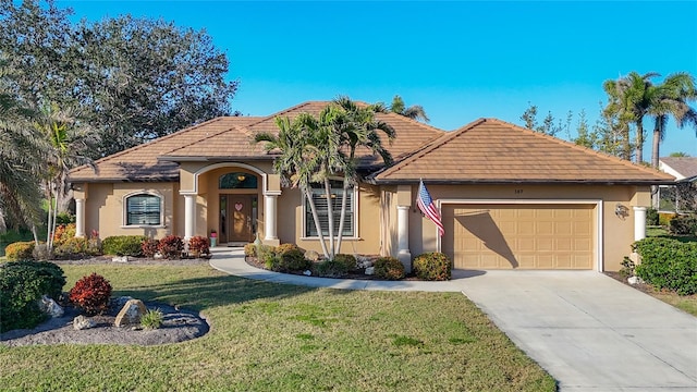 view of front of home with a garage and a front yard