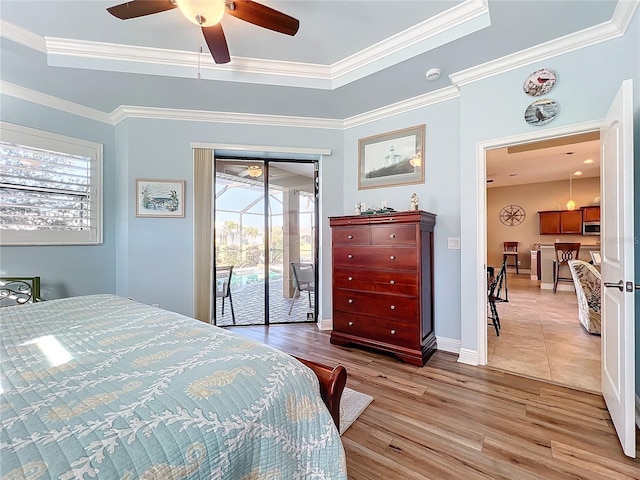 bedroom featuring access to outside, ornamental molding, and a raised ceiling