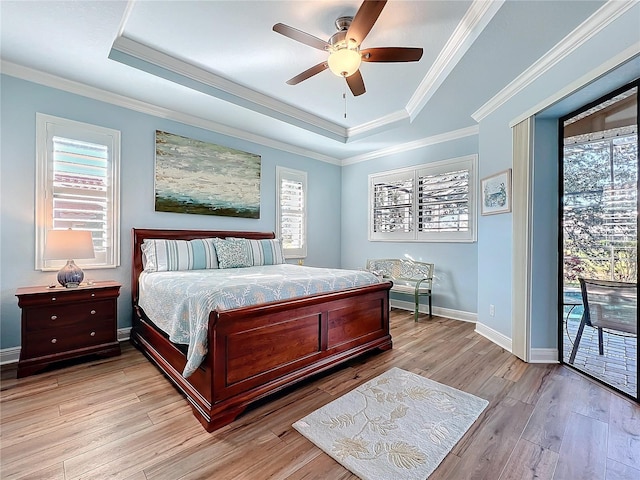 bedroom with multiple windows and a tray ceiling