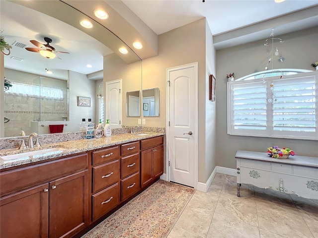 bathroom with vanity, tiled shower, and ceiling fan