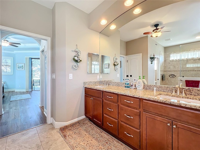 bathroom featuring vanity, ceiling fan, tile patterned flooring, and tiled shower