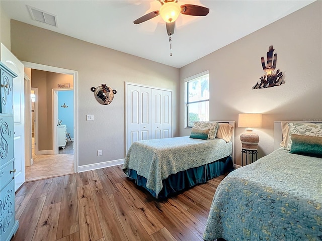 bedroom featuring hardwood / wood-style floors, ceiling fan, and a closet