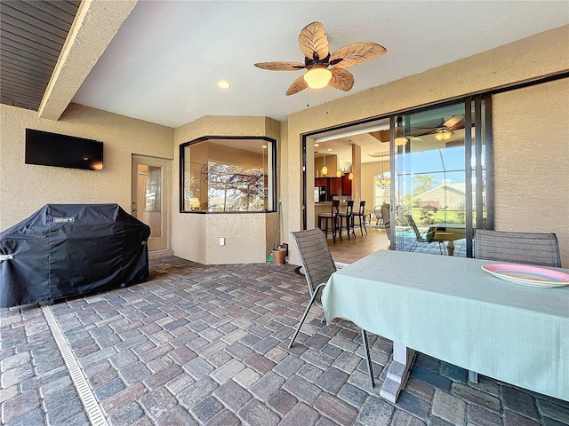 dining area with beam ceiling and ceiling fan