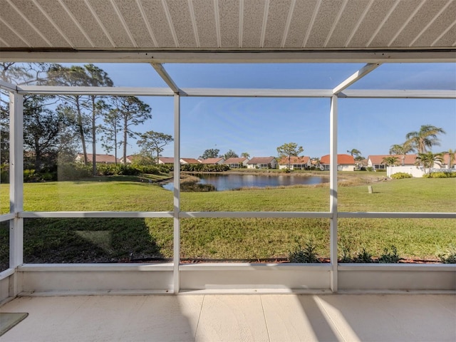 unfurnished sunroom with a water view and a healthy amount of sunlight