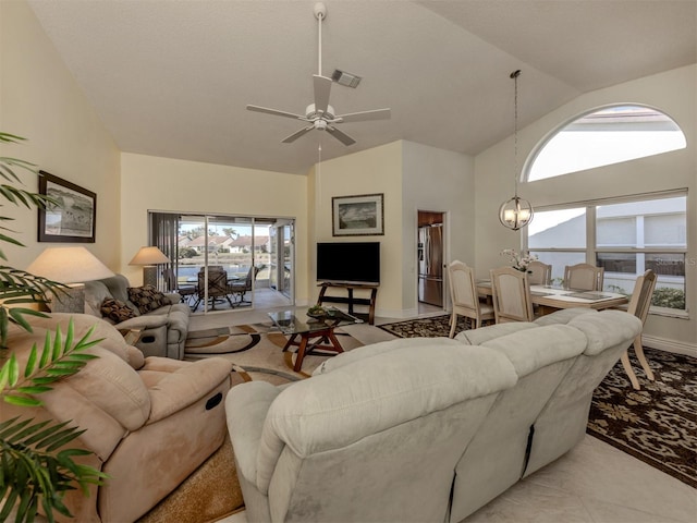 living room featuring ceiling fan with notable chandelier and high vaulted ceiling