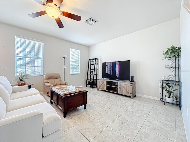 tiled living room featuring ceiling fan