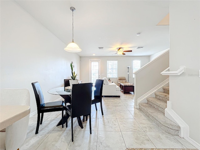 dining area with ceiling fan and tile patterned floors