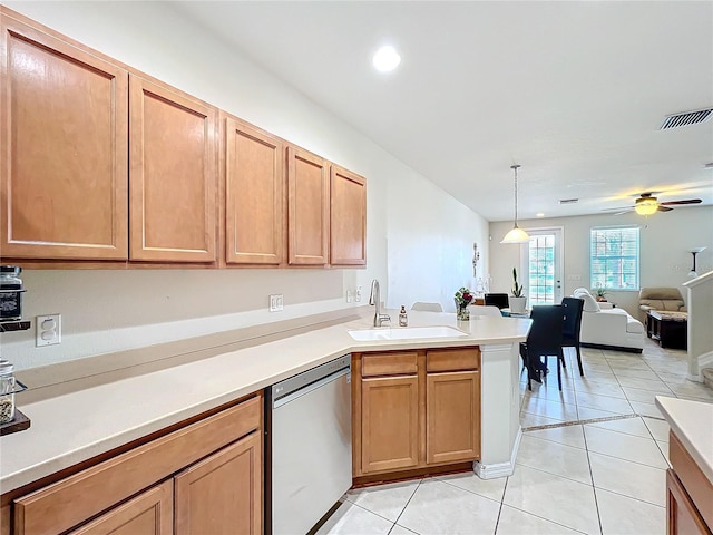 kitchen with light tile patterned flooring, sink, stainless steel dishwasher, and decorative light fixtures