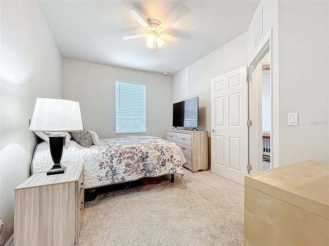 bedroom featuring ceiling fan and light carpet