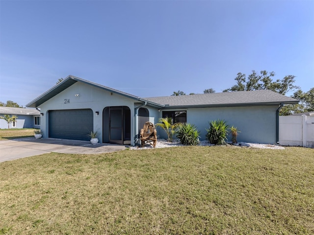 ranch-style home featuring a garage and a front lawn